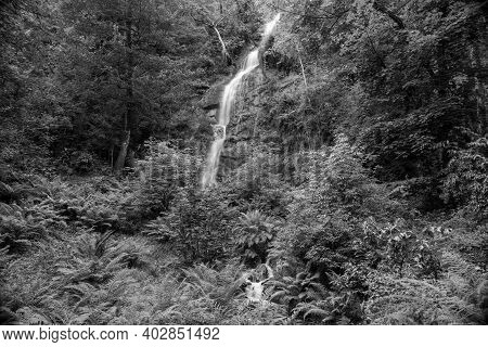 Long Exposure Of The Waterfall Flowing Over The Cliff At Canonteign Falls In Dartmoor