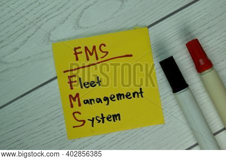 Fms - Fleet Management System Write On Sticky Notes Isolated On Wooden Table.
