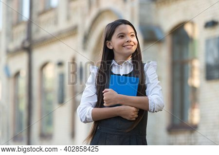 A New Education Perspective. Happy Child In Uniform Hold Book. School Library. Primary Education. Pr