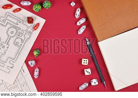 Tabletop Role Playing Flat Lay With Rpg Game Dices, Hand Drawn Dungeon Map, Rule Books And Pen On Re