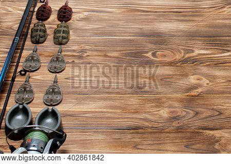 Flat Lay With Fishing Tackle, Fishing Rod And Plastic Box With Fishing Tackle And Hooks, Feeders On