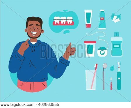 Man Showing His Smile With Dental Braces. Attractive Guy With Various Accessories For Daily Dental C