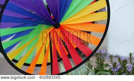 Colorful Pinwheel Spinning, Weather Wind Vane, Garden Decoration In Usa. Rainbow Symbol Of Childhood