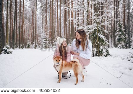 Happy Family Young Mother And Little Cute Girl In Pink Warm Outwear Walking Having Fun With Red Shib