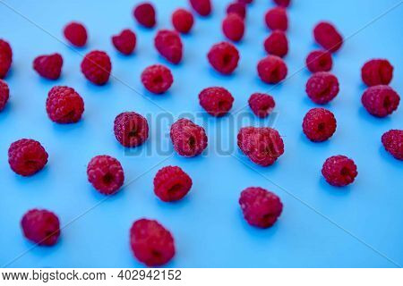 Raspberry Pattern, Blue Background, Top View\rpattern Of Ripe Red Raspberry On Blue Background. Vega