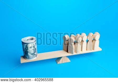 A Group Of People And A Bundle Of Dollars On The Scales. Financial Support In A Difficult Economic S