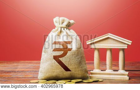 Indian Rupee Money Bag And Bank / Government Building. Tax Collection And Budgeting. Gdp And Gnp. Mo
