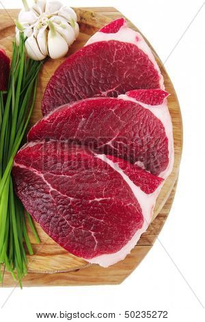 uncooked meat : raw fresh beef pork rib and fillet ready to cooking with garlic and green stuff over wood isolated on white background