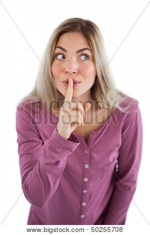 Woman saying to be quiet with finger on lips