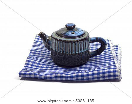 Blue teapot on the napkin