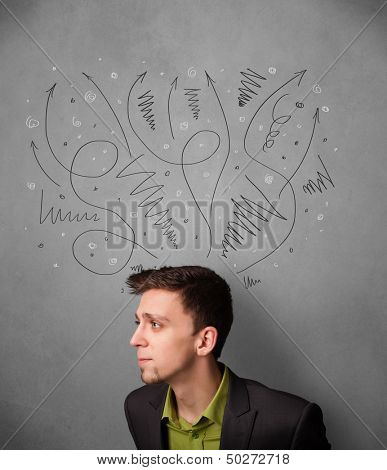 Young businessman deciding with sketched arrows over his head