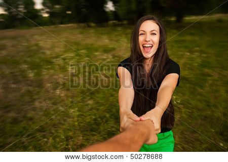 Young Happy Woman Spinning Around Holding Man's Hand