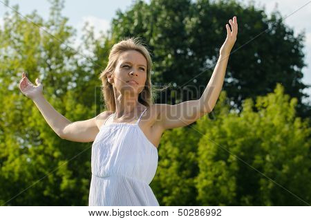 young woman practicing yoga in nature
