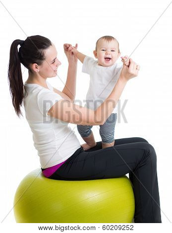 Mother And Baby Having Fun With  Gymnastic Ball