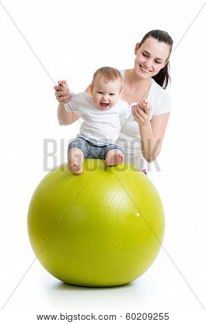 Mother Playing With Baby On Fit Ball