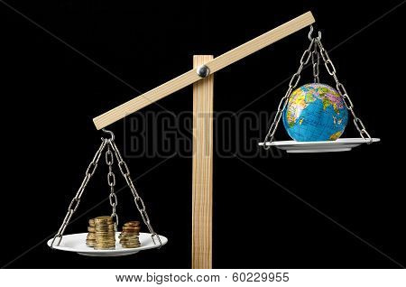 Earth and Money on a Two Pan Balance