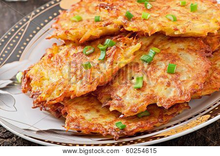 Fried potato pancakes on the old wooden background