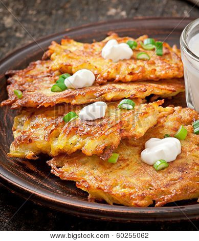 Fried potato pancakes on the old wooden background