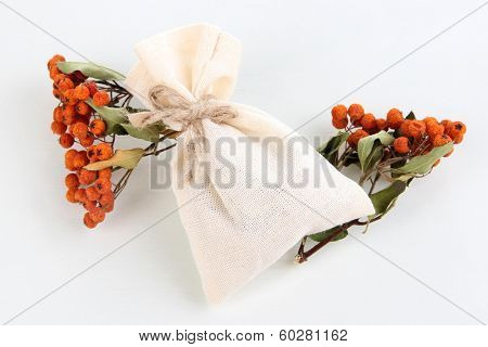 Textile sachet pouch with dried berries isolated on white