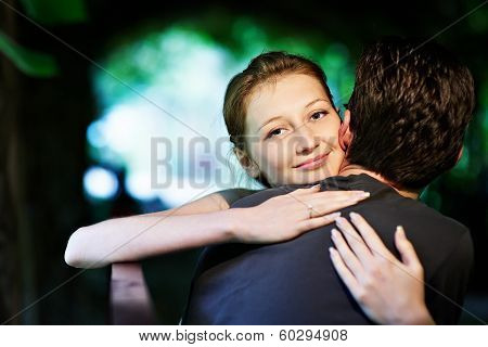 Happy Girl In The Arms Of Her Fiance In Park