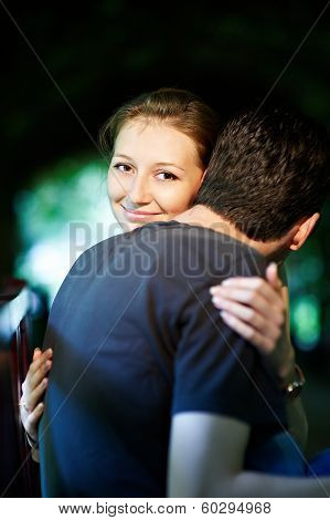 Happy Girl In The Arms Of Her Fiance In Park