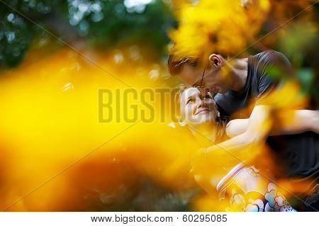 Happy Girl In The Arms Of Her Boyfriend Among Flowers