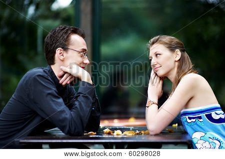 Man And Woman At A Table In Cafe