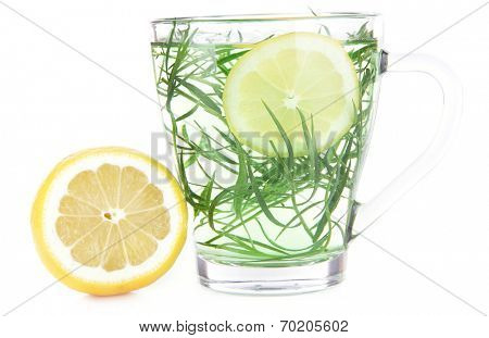 Glass of estragon drink with lemon isolated on white