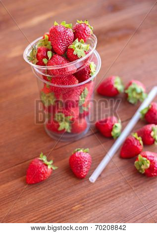 Strawberry In Takeaway Cup On The Wooden Table