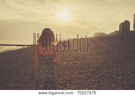 Young Woman On The Beach At Sunset