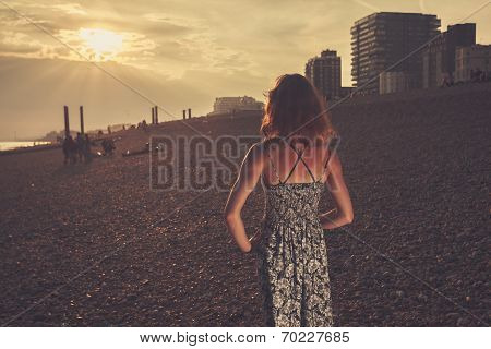 Young Woman On The Beach At Sunset