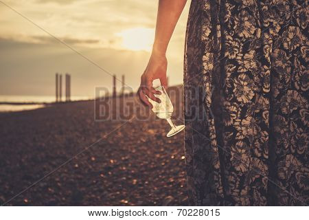 Young Woman On The Beach With Glass Of Wine