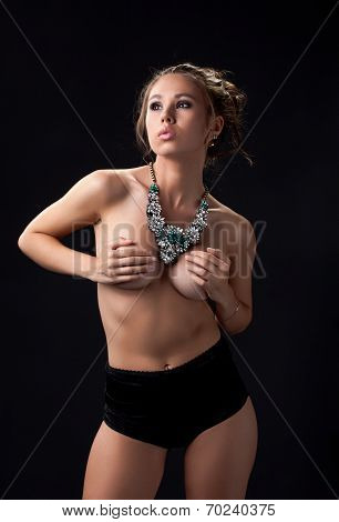 Pretty model posing in shorts and heavy necklace