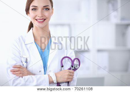 Portrait of happy successful young female doctor holding a stet