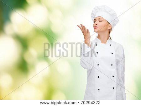 cooking, gesture and food concept - smiling female chef showing delicious gesture