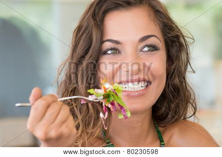 Young Smiling Girl Eating Salad At Luch Break From Work 