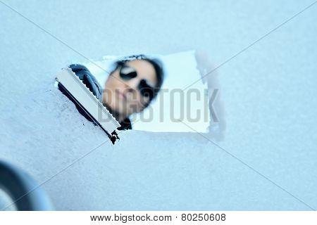 Winter Driving - Woman with Sunglasses Scraping Ice from a Windshield