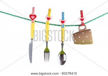Crockery dried on rope isolated on white