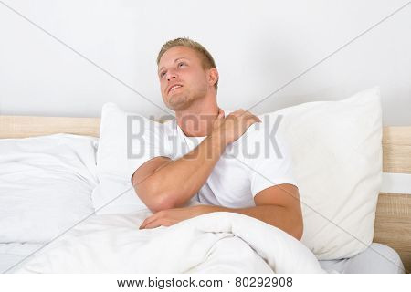 Young Man Suffering From Shoulder Pain