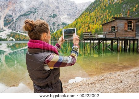 Woman At Lake Bries Taking Scenic Photo With Digital Tablet