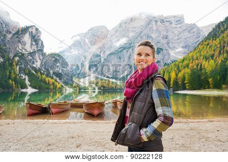 Woman On Shores Of Lake Bries With Wooden Boats In Background