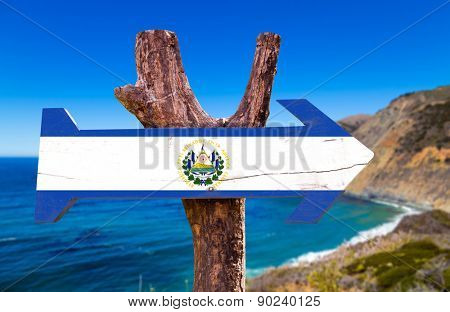 El Salvador Flag wooden sign with coast background