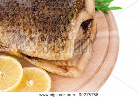 Fried carp tail with lemon and pepper.
