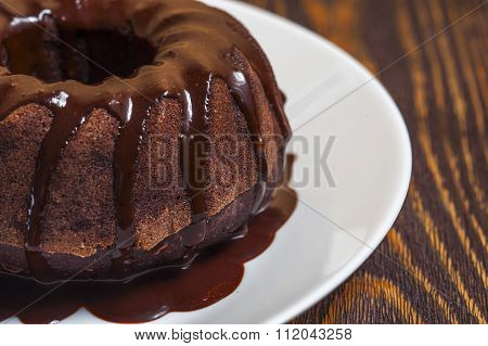 Chocolate cake  with glaze on the white plate
