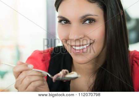 Beautiful girl eating fresh delicious calamari cebiche