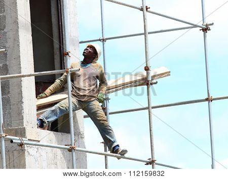 CUREPIPE, MAURITIUS ISLAND - 28. OCTOBER, 2015: Unidentified African worker on a scaffold build new touristic resort on the Mauritius coast.