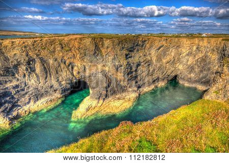 Beautiful Wine Cove Cornwall coast turquoise blue sea with snorkellers in HDR near Treyarnon