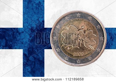 Finnish Two Euros Coin With Flag Of Finland As Background