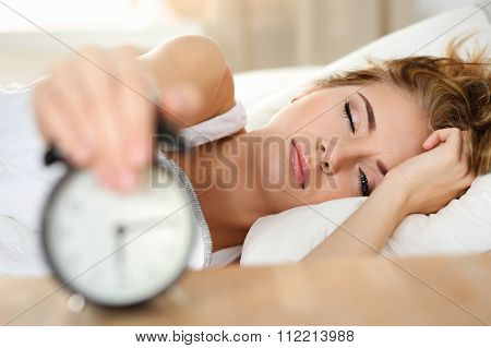Sleepy Young Woman Portrait With One Opened Eye Trying Kill Alarm Clock