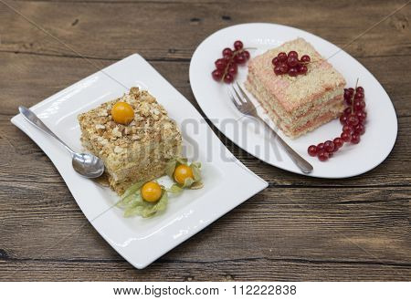 Fresh delicious diet cake with berry Physalis and red currant at Dukan Diet on a porcelain plate with a spoon on a wooden background